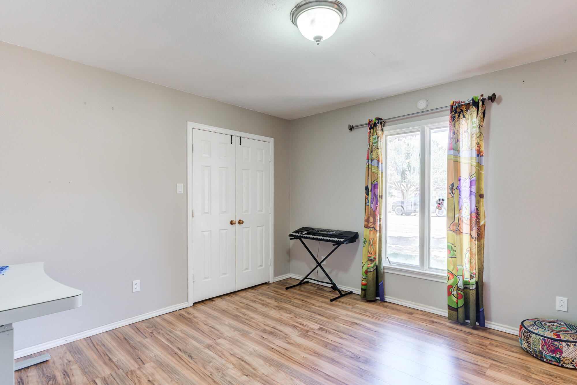 4507 8th Street Lubbock, TX 79416 - Photo 27 of 42 a view of an empty room with wooden floor and a window