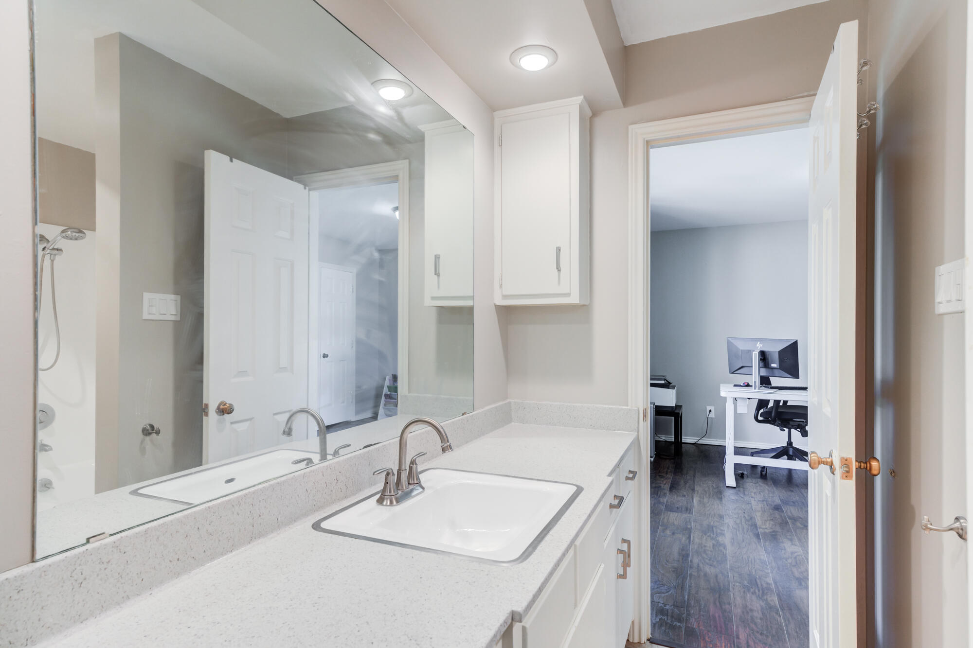 4507 8th Street Lubbock, TX 79416 - Photo 29 of 42 a en suite bathroom with a sink and a mirror