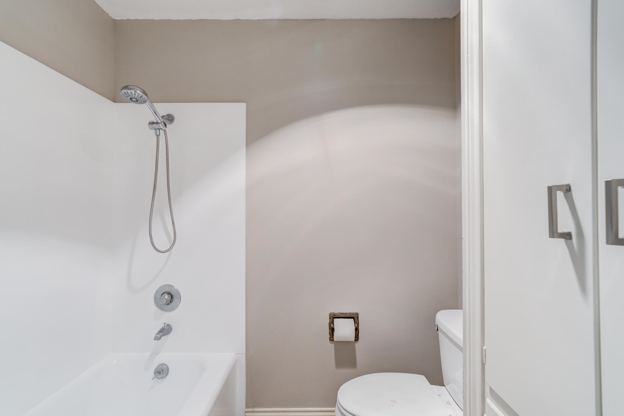4507 8th Street Lubbock, TX 79416 - Photo 30 of 42 a bathroom with a granite countertop toilet and a shower