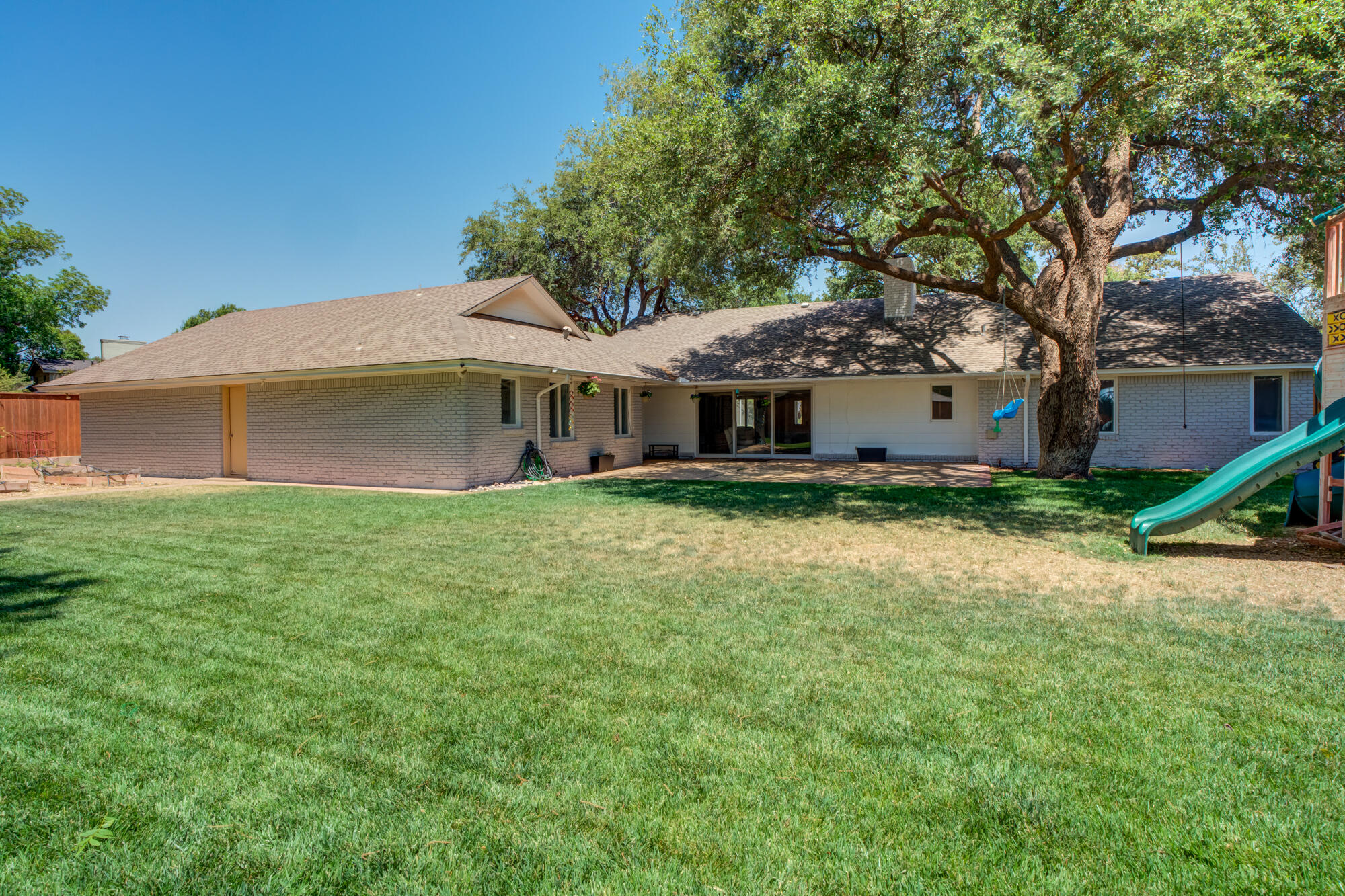 4507 8th Street Lubbock, TX 79416 - Photo 3 of 42 a front view of a house with a garden and trees