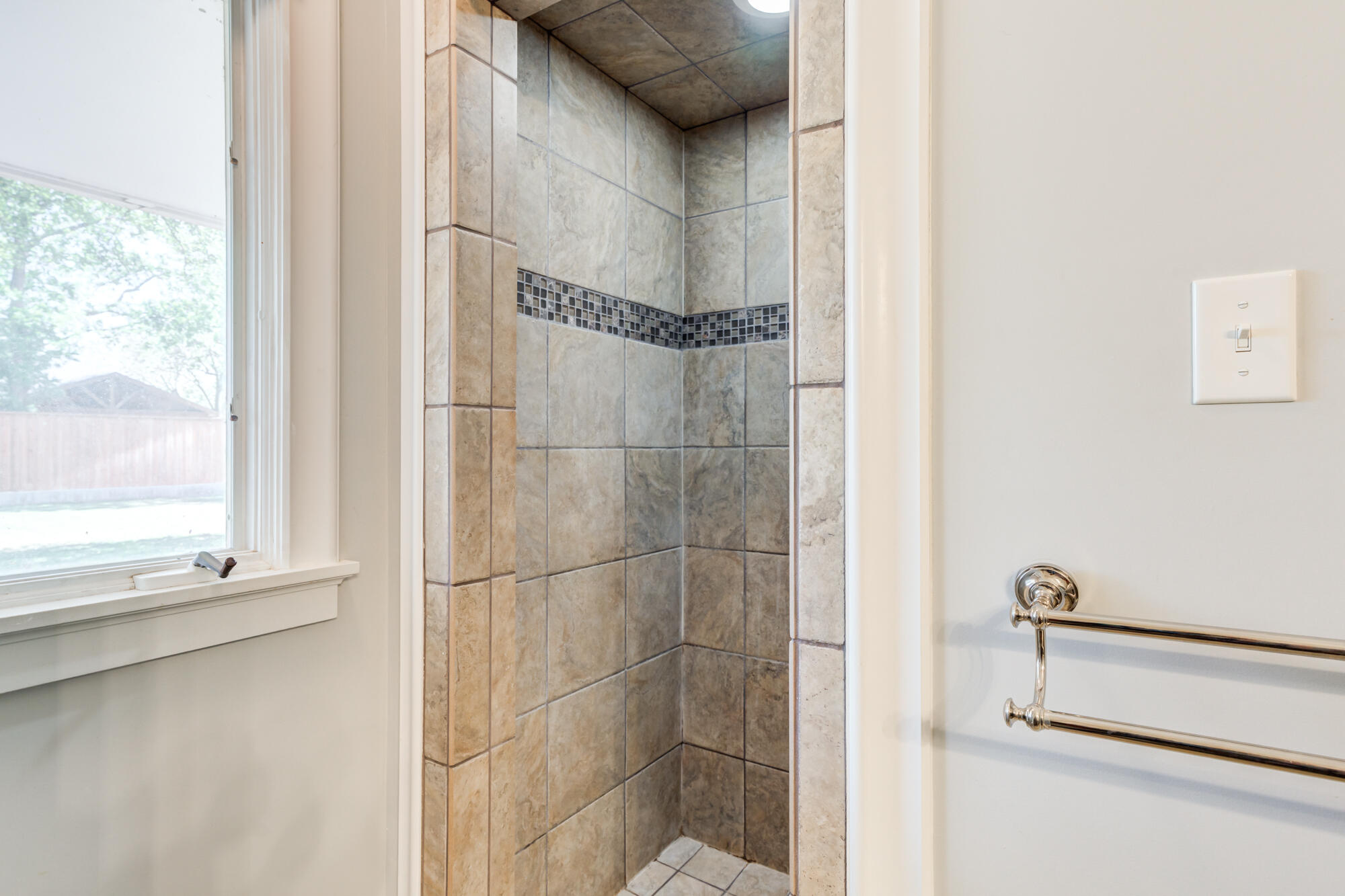 4507 8th Street Lubbock, TX 79416 - Photo 34 of 42 a bathroom with a glass shower door