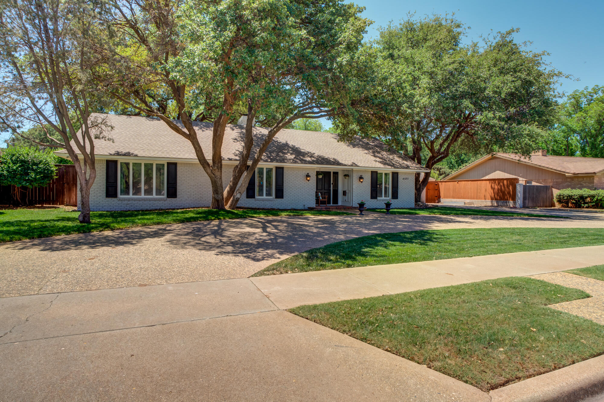 4507 8th Street Lubbock, TX 79416 - Photo 40 of 42 a front view of house with yard and green space