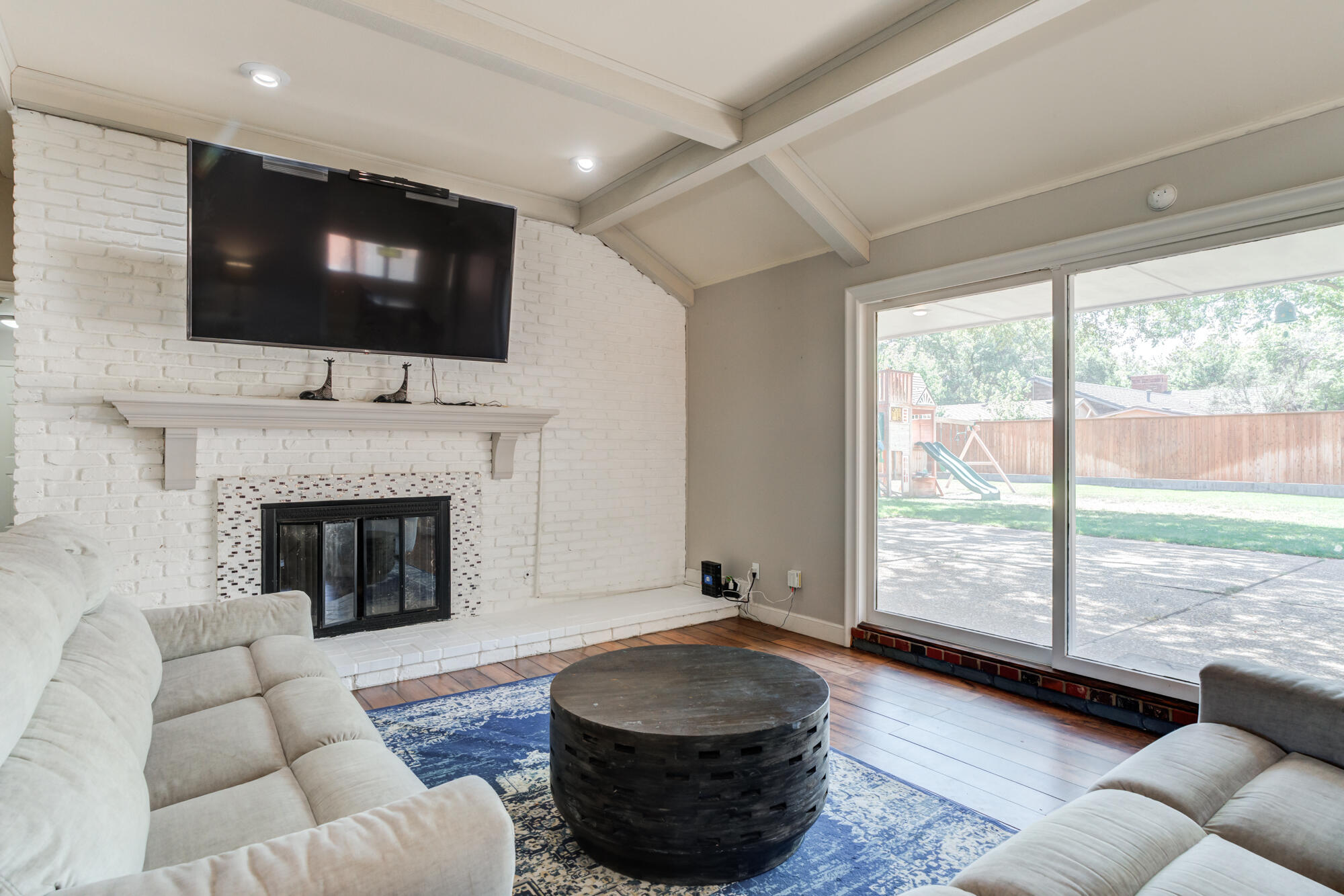 4507 8th Street Lubbock, TX 79416 - Photo 10 of 42 a living room with furniture fireplace and flat screen tv