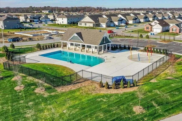 an aerial view of a house with a garden and lake view