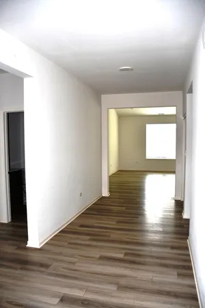 a view of a room with wooden floor