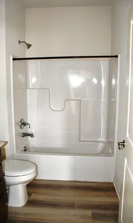 a bathroom with a toilet and a shower