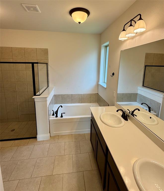 204 Flower Ridge Drive Fort Worth, TX 76108 - Photo 20 of 27 a bathroom with a tub sink and mirror