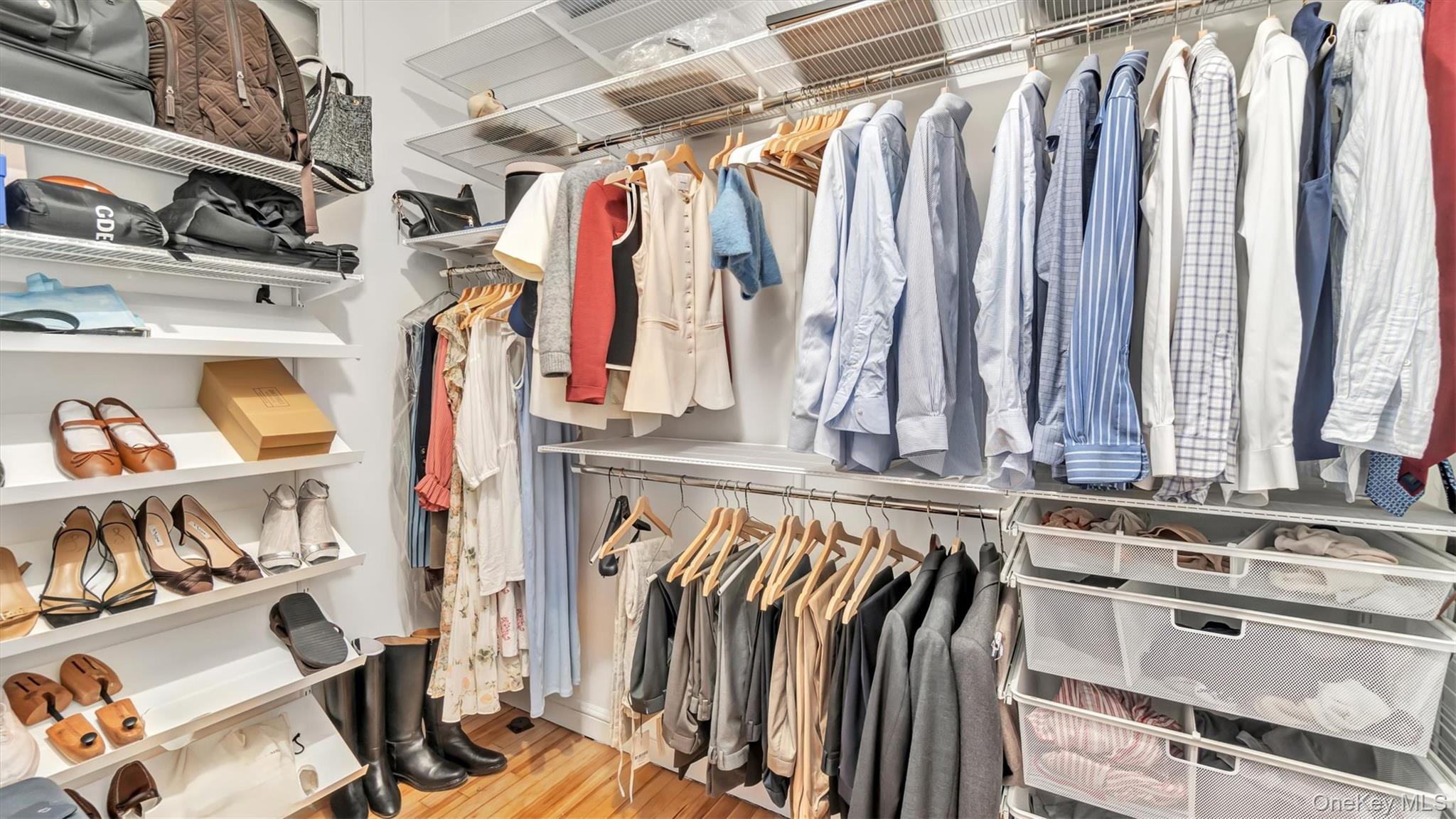 8 Barstow Road, Unit 7H Great Neck, NY 11021 - Photo 15 of 27 a view of walk in closet with clothes and shoes