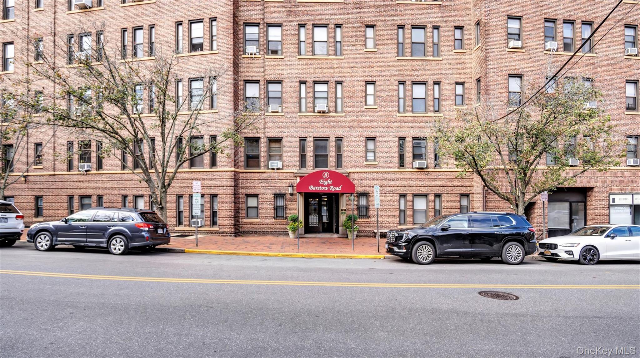 8 Barstow Road, Unit 7H Great Neck, NY 11021 - Photo 3 of 27 a car parked in front of a building