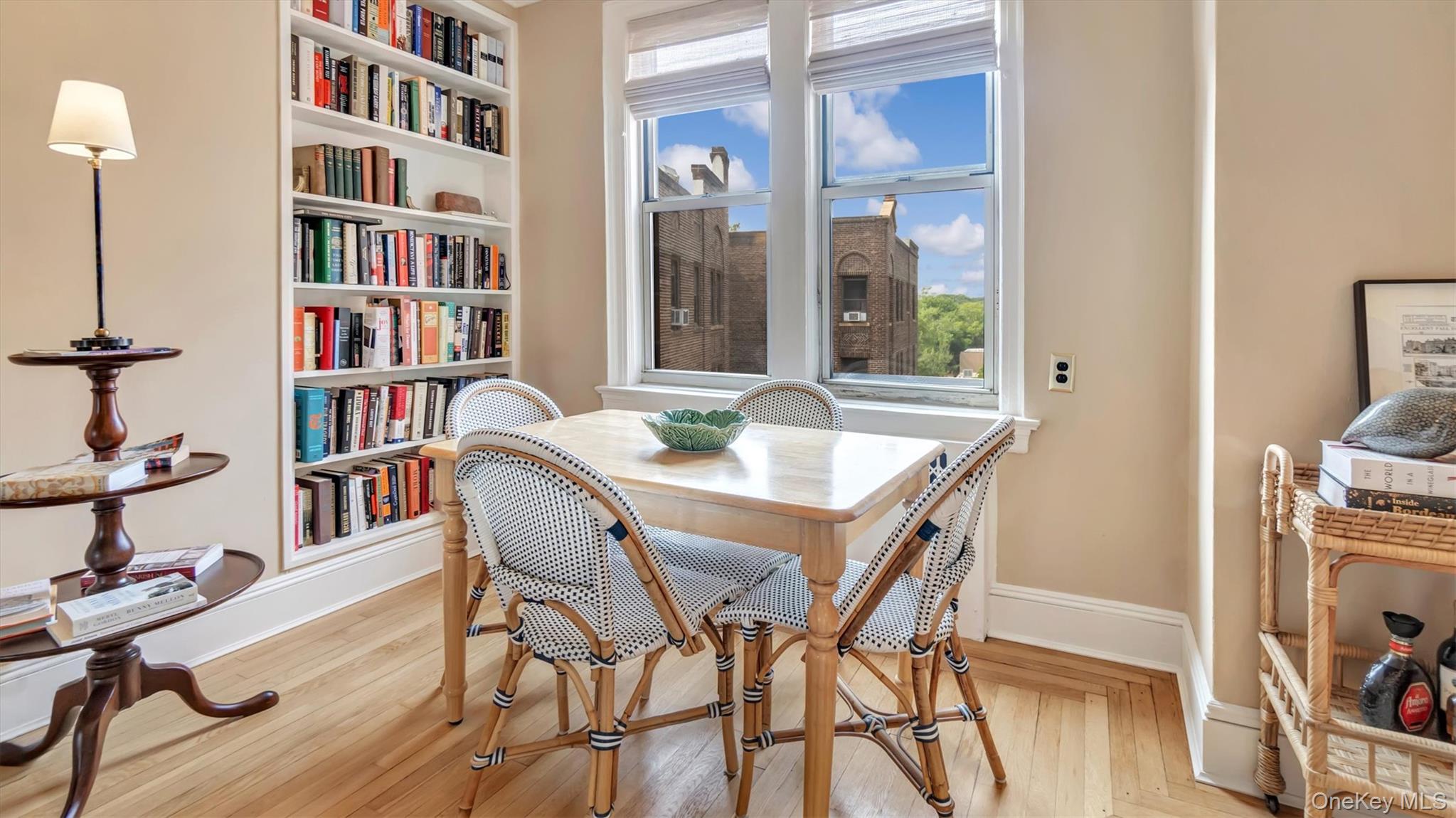 8 Barstow Road, Unit 7H Great Neck, NY 11021 - Photo 7 of 27 a view of a dining room with furniture and a book shelf