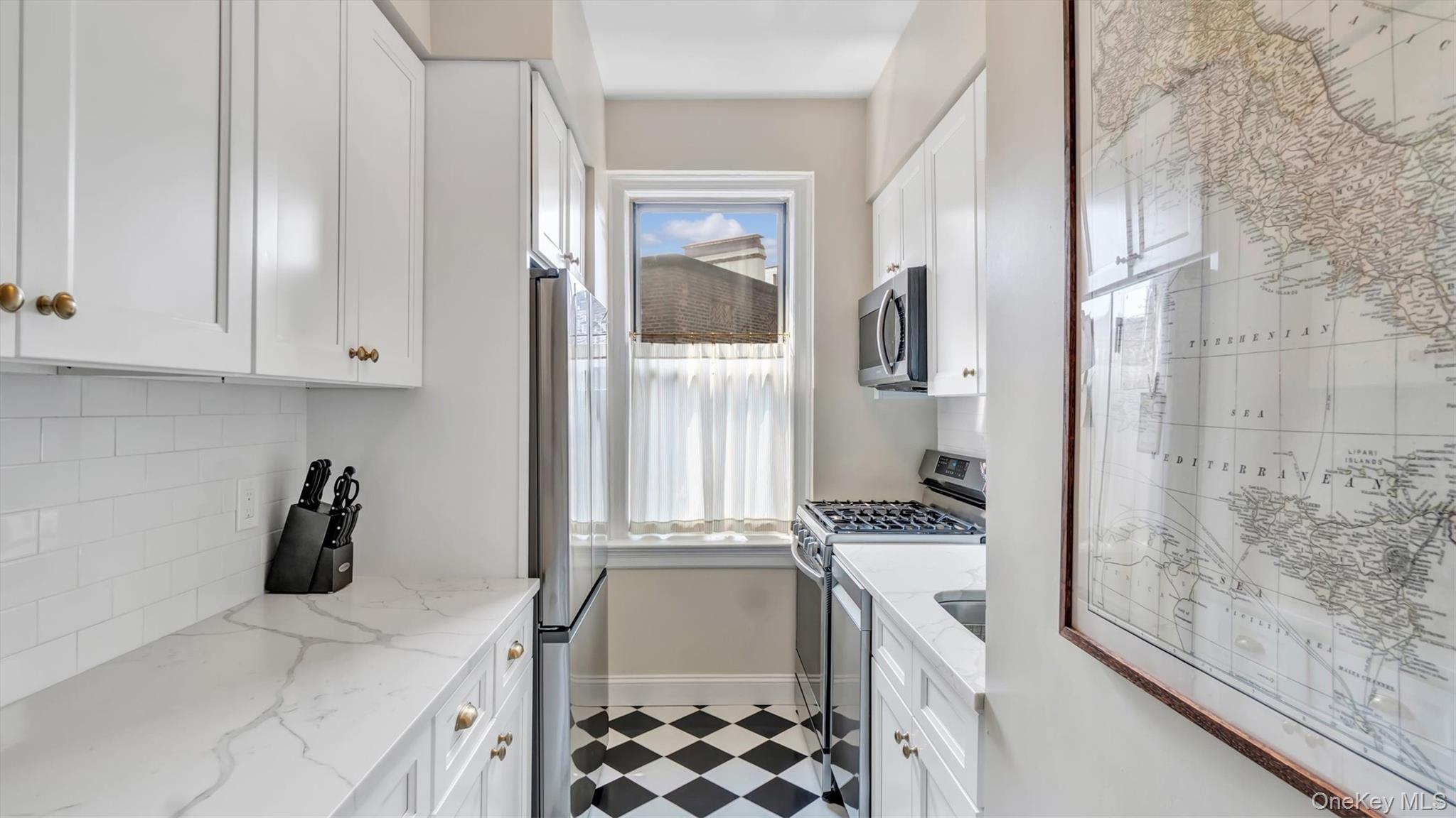 8 Barstow Road, Unit 7H Great Neck, NY 11021 - Photo 8 of 27 a bathroom with a granite countertop sink a vanity and window