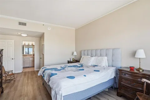 a bedroom with a bed and a lamp on table