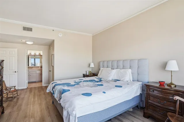 a bedroom with a bed and a lamp on table