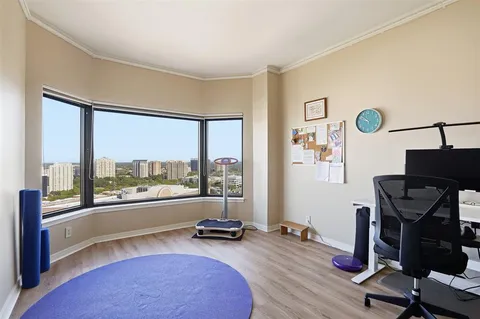 a view of a workspace with furniture and a window