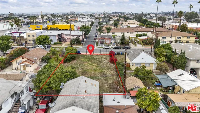 an aerial view of a houses with a swimming pool