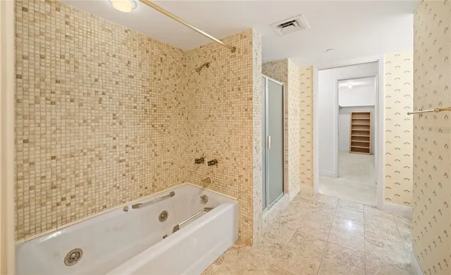 a bathroom with a bathtub and a shower