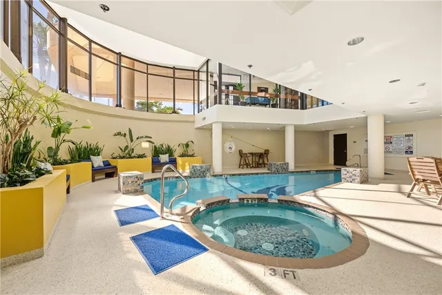 a view of a house with swimming pool and sitting area