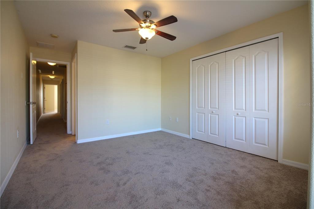 5433 Quarry Rock Road Lakeland, FL 33809 - Photo 15 of 26 an empty room with closet and a chandelier fan