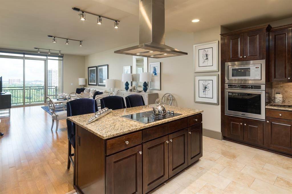 7 Riverway, Unit 2011 Houston, TX 77056 - Photo 12 of 25 a kitchen with granite countertop a sink counter top space appliances and cabinets
