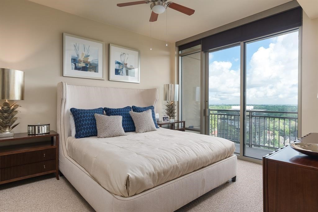 7 Riverway, Unit 2011 Houston, TX 77056 - Photo 2 of 25 a bedroom with a large bed and a balcony view