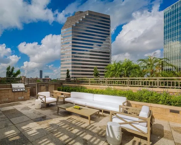a view of swimming pool with outdoor seating and city view