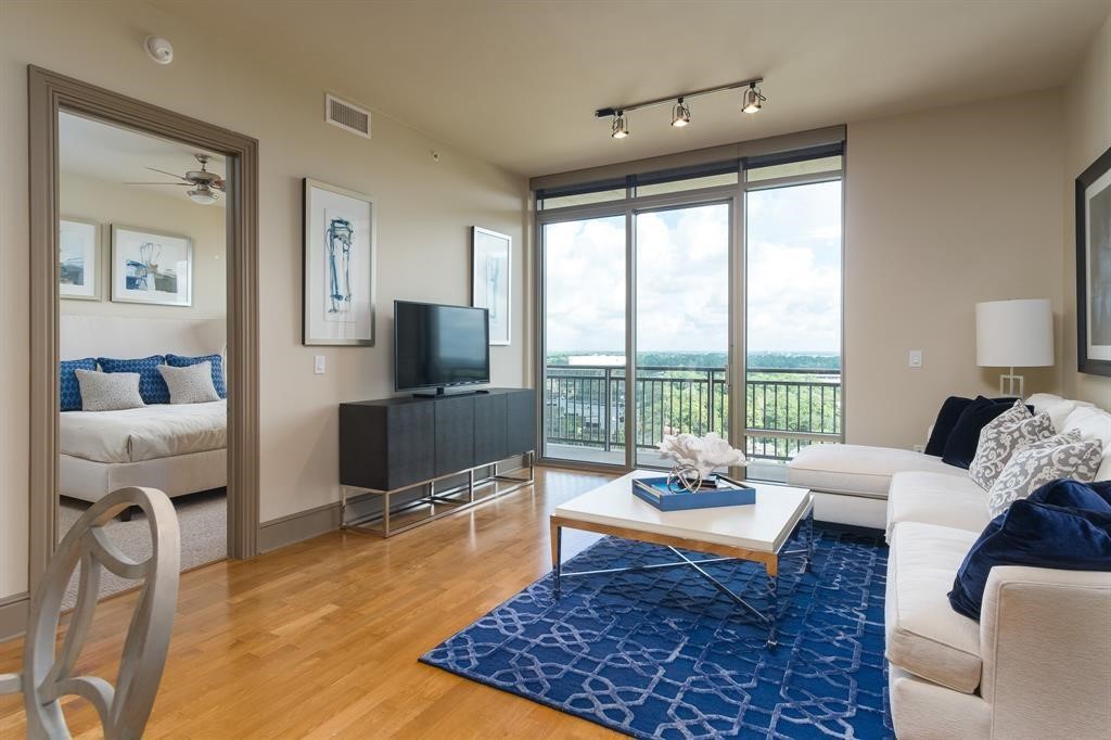 7 Riverway, Unit 2011 Houston, TX 77056 - Photo 9 of 25 a living room with furniture and a flat screen tv