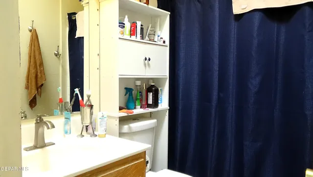 a bathroom with a sink vanity and a mirror