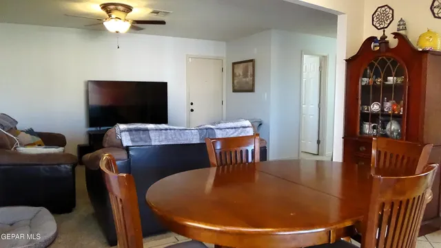 a dining room with furniture and wooden floor