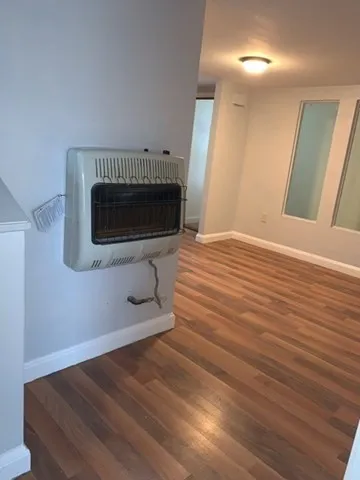 a room with wooden floor and a fireplace