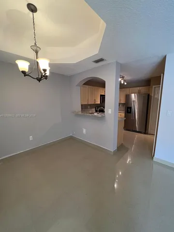 a view of a kitchen with a sink hardwood floor and a ceiling fan