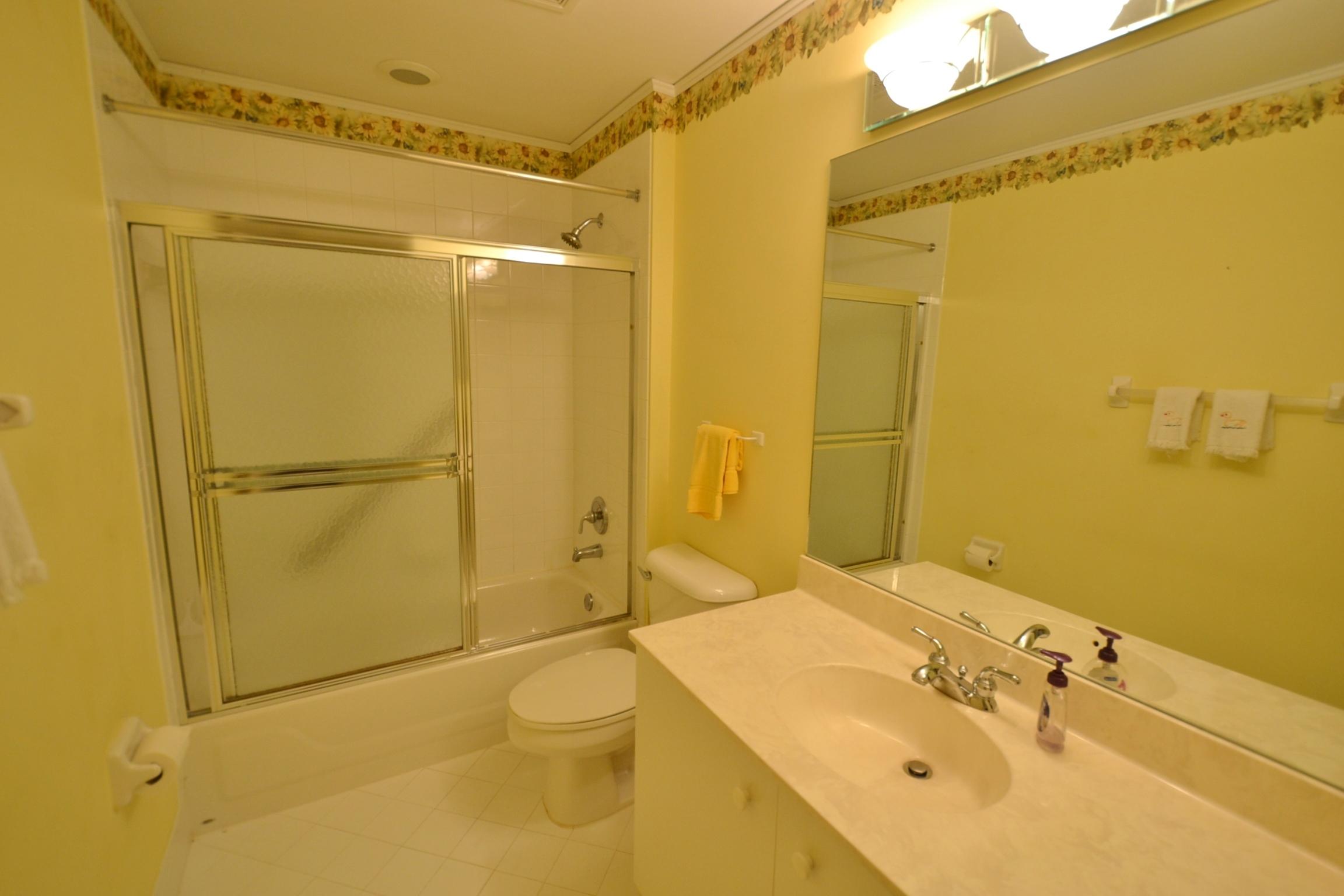 112 West Lee Road Delray Beach, FL 33445 - Photo 25 of 30 a bathroom with a sink mirror toilet and shower
