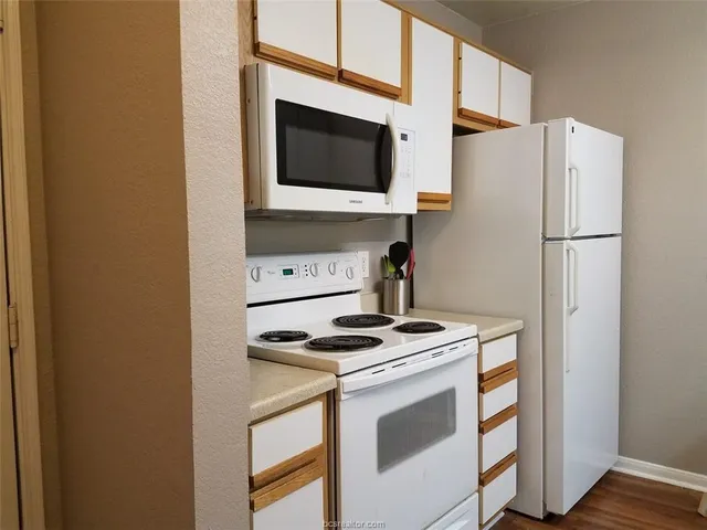 a kitchen with a stove microwave and refrigerator