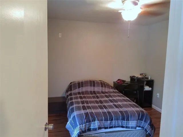 a bedroom with a bed and lamp