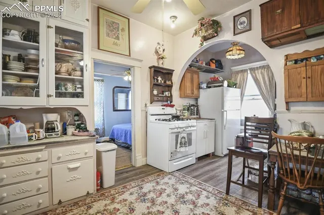 a view of a kitchen with furniture and wooden floor