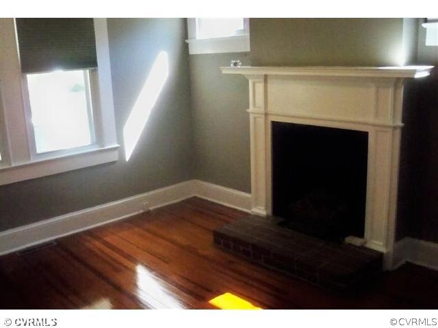 913 Osborn Road Farmville, VA 23901 - Photo 2 of 9 a view of an empty room with wooden floor and a fireplace