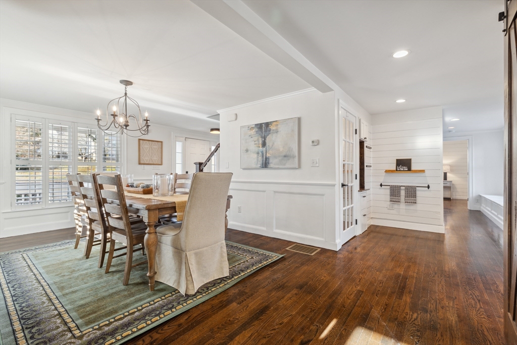 83 County Road Reading, MA 01867 - Photo 16 of 42 a dining room with furniture a chandelier and wooden floor
