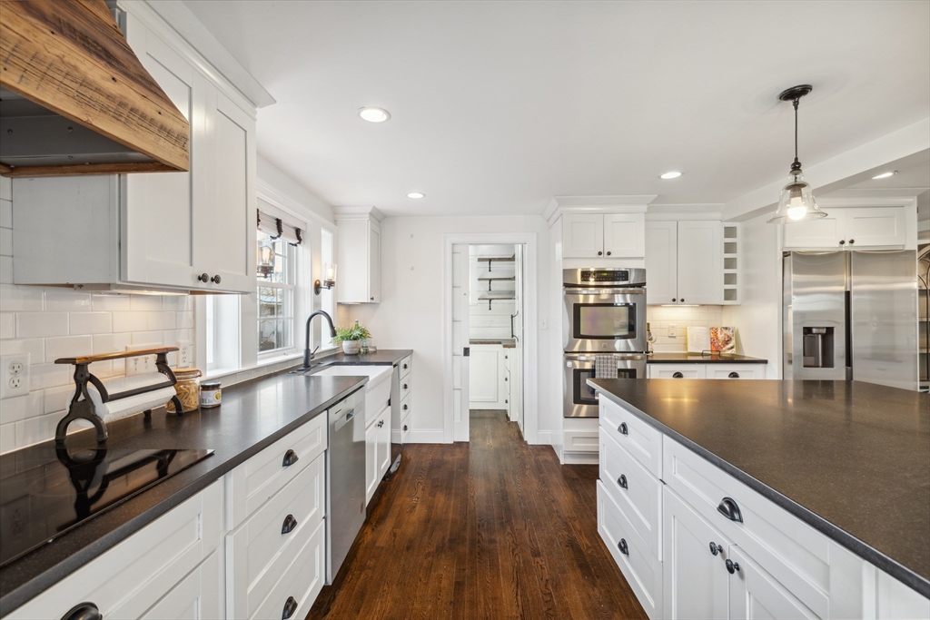 83 County Road Reading, MA 01867 - Photo 19 of 42 a kitchen with stainless steel appliances granite countertop a sink stove and refrigerator