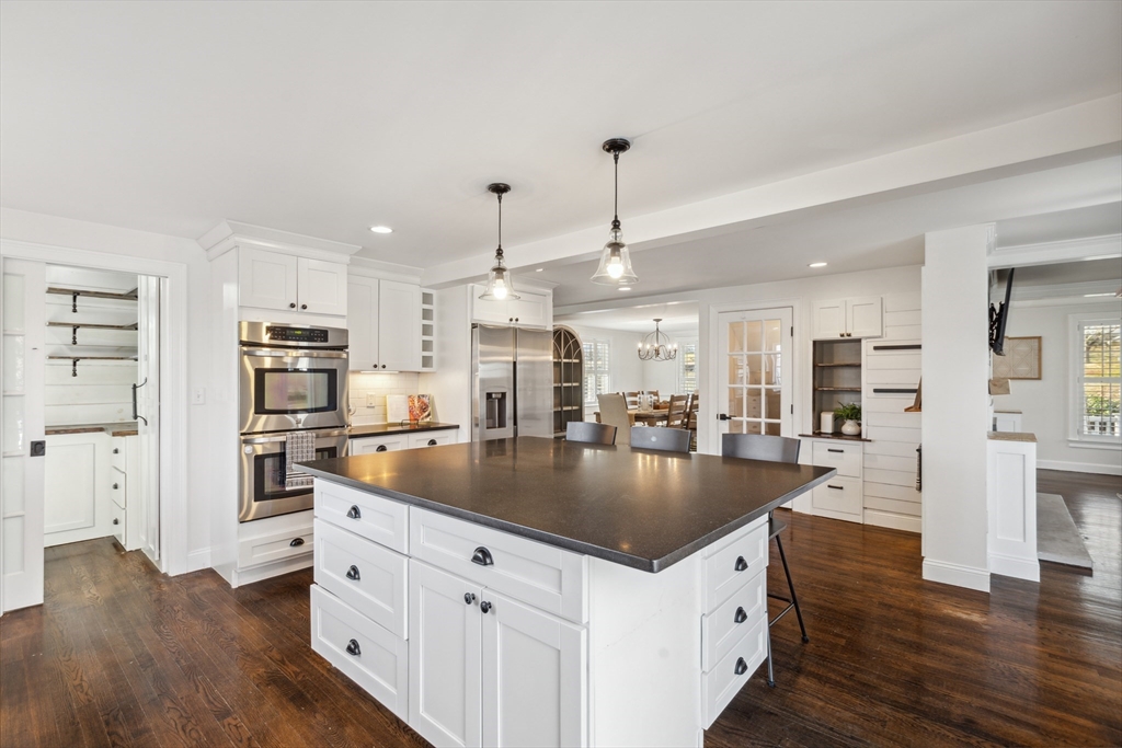 83 County Road Reading, MA 01867 - Photo 20 of 42 a kitchen with stainless steel appliances granite countertop a sink a stove and a refrigerator