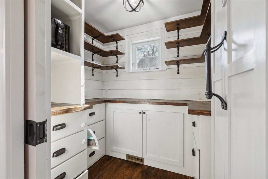 83 County Road Reading, MA 01867 - Photo 21 of 42 a kitchen with cabinets and wooden floor
