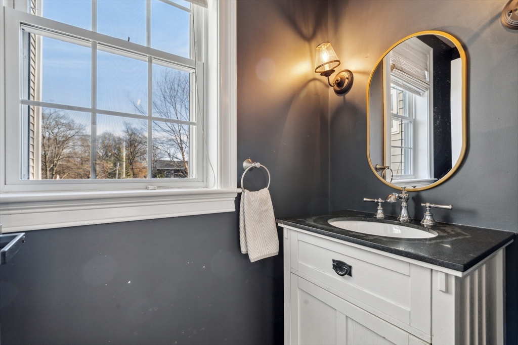 83 County Road Reading, MA 01867 - Photo 25 of 42 a bathroom with a double vanity sink and a mirror