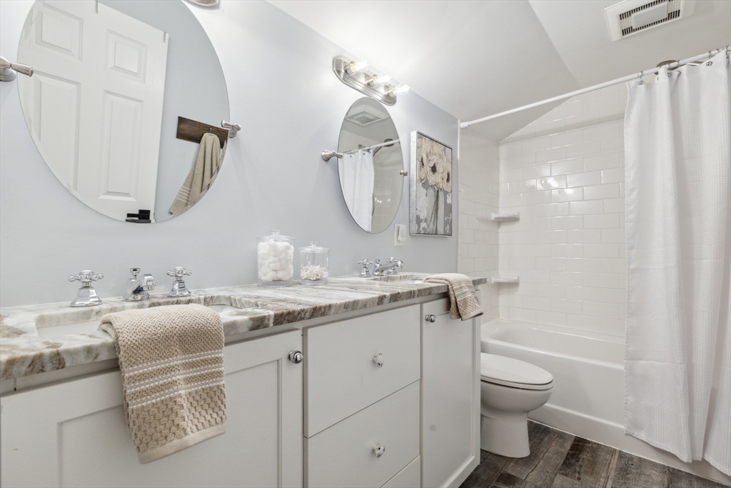 83 County Road Reading, MA 01867 - Photo 34 of 42 a bathroom with a granite countertop sink a toilet and a mirror