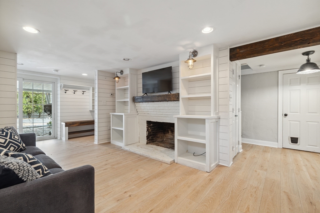 83 County Road Reading, MA 01867 - Photo 38 of 42 a living room with furniture flat screen tv and a fireplace