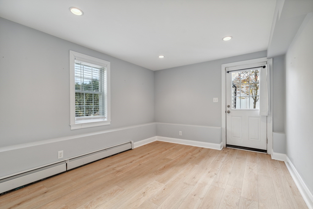83 County Road Reading, MA 01867 - Photo 41 of 42 an empty room with wooden floor and windows