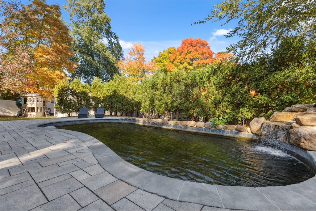 83 County Road Reading, MA 01867 - Photo 6 of 42 a view of a swimming pool with a patio