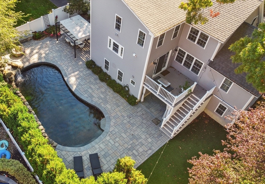 83 County Road Reading, MA 01867 - Photo 7 of 42 an aerial view of a house with a swimming pool and outdoor space