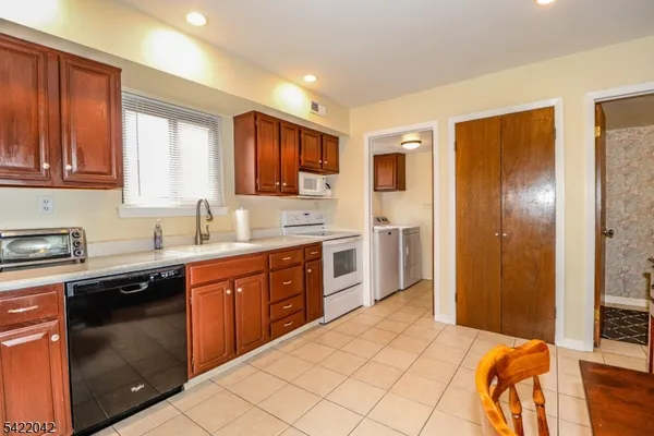a kitchen with stainless steel appliances granite countertop a refrigerator and sink