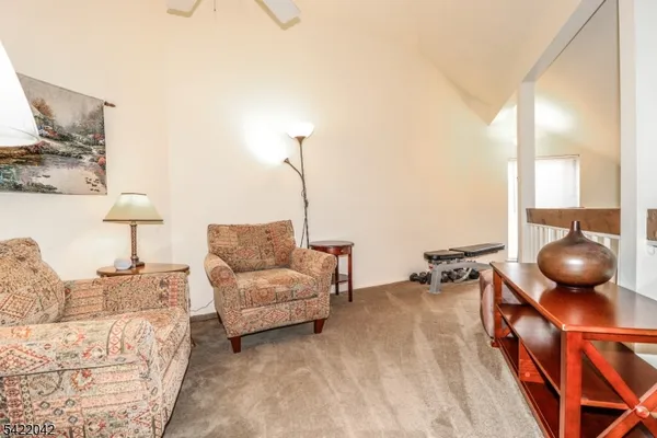 a living room with furniture and a lamp