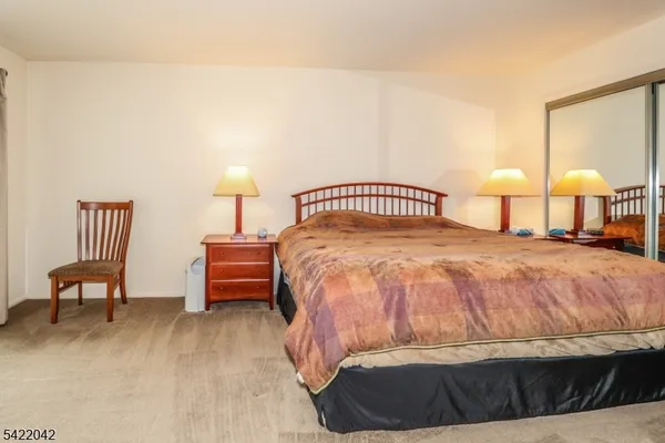 a bedroom with a bed and a lamp