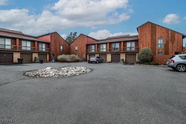 a view of a car park in front of a house