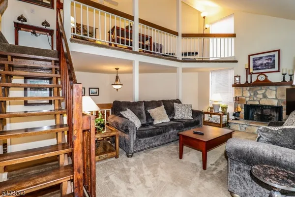 a living room with furniture a fireplace and a window